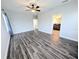 Spacious bedroom with plank flooring, large windows, and tasteful curtains creating a bright ambiance at 32599 Natural Bridge Rd, Wesley Chapel, FL 33543