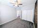 Bedroom with a ceiling fan, double closets, plush carpet, and neutral paint at 32599 Natural Bridge Rd, Wesley Chapel, FL 33543