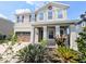 Charming two-story home featuring a covered front porch and a well-manicured, landscaped front yard at 32599 Natural Bridge Rd, Wesley Chapel, FL 33543