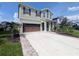 Beautiful two-story home with a well-manicured lawn, private driveway, and attached two-car garage at 32599 Natural Bridge Rd, Wesley Chapel, FL 33543