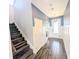Inviting hallway with wood-look floors, white doors, and staircase leading to the upper level at 32599 Natural Bridge Rd, Wesley Chapel, FL 33543
