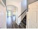 Bright hallway featuring wood-look tile floors, a staircase, and doorways leading to other rooms at 32599 Natural Bridge Rd, Wesley Chapel, FL 33543