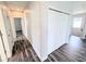 Upstairs hallway with wood-look floors and large closet at 32599 Natural Bridge Rd, Wesley Chapel, FL 33543