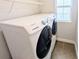 Laundry room with Samsung washer and dryer, wire shelving, and tiled floor at 32599 Natural Bridge Rd, Wesley Chapel, FL 33543
