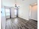 Open living room features stylish wood-look flooring, ceiling fan, and lots of natural light at 32599 Natural Bridge Rd, Wesley Chapel, FL 33543