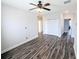 Bright living room with ceiling fan, wood-look floors, closet and neutral paint at 32599 Natural Bridge Rd, Wesley Chapel, FL 33543