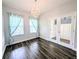 Bright office space with beautiful hardwood floors, a modern light fixture, and stylish built-in shelves at 32599 Natural Bridge Rd, Wesley Chapel, FL 33543