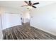 Upstairs hall with wood-look floors, closet, and neutral paint throughout at 32599 Natural Bridge Rd, Wesley Chapel, FL 33543