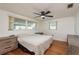 Main bedroom features hardwood floors, two windows, and modern ceiling fan at 3547 Morley Dr, New Port Richey, FL 34652