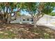 A cute single-Gathering home featuring mature trees and a manicured lawn, providing excellent shade and curb appeal at 3547 Morley Dr, New Port Richey, FL 34652