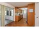 Galley kitchen with wooden cabinets, a white tile backsplash, and a stainless steel refrigerator, perfect for home cooking at 3547 Morley Dr, New Port Richey, FL 34652