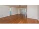 Bright living room featuring hardwood floors, white walls, and natural light from the windows, creating a warm, inviting space at 3547 Morley Dr, New Port Richey, FL 34652