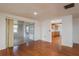 Spacious living room with hardwood floors and access to the kitchen and screened-in lanai, ideal for entertaining guests at 3547 Morley Dr, New Port Richey, FL 34652