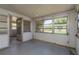 This sun room has a door leading to the exterior and multiple windows at 3547 Morley Dr, New Port Richey, FL 34652