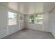 Sunroom with multiple windows and concrete floors at 3547 Morley Dr, New Port Richey, FL 34652