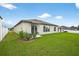 View of the back of the home featuring an ample yard space and newly installed white vinyl fencing at 36618 Garden Wall Way, Zephyrhills, FL 33541