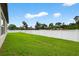 Large, well-manicured backyard featuring lush green grass and a pristine white fence at 36618 Garden Wall Way, Zephyrhills, FL 33541