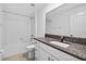 Bathroom with granite countertop, white cabinets, and tiled shower/tub combo at 36618 Garden Wall Way, Zephyrhills, FL 33541