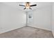Bedroom featuring a window, carpet flooring, and a ceiling fan at 36618 Garden Wall Way, Zephyrhills, FL 33541
