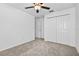Bedroom with ceiling fan, carpet, closet, and door at 36618 Garden Wall Way, Zephyrhills, FL 33541