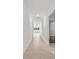 A bright hallway with tile flooring leading to a room with large windows and a ceiling fan at 36618 Garden Wall Way, Zephyrhills, FL 33541