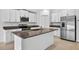 Kitchen island featuring granite countertops, stainless steel appliances, and white cabinetry at 36618 Garden Wall Way, Zephyrhills, FL 33541