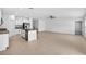 Spacious open kitchen with granite countertops, stainless steel appliances, and tile flooring at 36618 Garden Wall Way, Zephyrhills, FL 33541