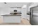 Modern kitchen featuring granite countertops, stainless steel appliances, and white cabinetry at 36618 Garden Wall Way, Zephyrhills, FL 33541