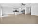 Bright open floor plan with tile flooring and white cabinets in the kitchen at 36618 Garden Wall Way, Zephyrhills, FL 33541