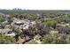An elevated shot shows a single story home covered by trees, with a city skyline in the background at 4009 N 15Th St, Tampa, FL 33610