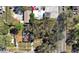 Aerial view of a property showcasing mature trees, the home, and surrounding neighborhood at 4009 N 15Th St, Tampa, FL 33610