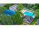 Community amenities include tennis court and swimming pool with lounge chairs surrounded by lush greenery at 4012 Tumble Wood Trl # 104, Tampa, FL 33613