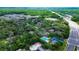 Overhead view of neighborhood featuring tree-lined streets and community pool at 4012 Tumble Wood Trl # 104, Tampa, FL 33613