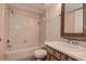 Bathroom featuring a bathtub, toilet, and sink with wood-grain cabinets at 4012 Tumble Wood Trl # 104, Tampa, FL 33613