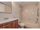 Bathroom features a shower-tub combo, single sink vanity with wood cabinets and tile flooring at 4012 Tumble Wood Trl # 104, Tampa, FL 33613