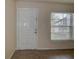 Inviting entrance featuring a solid white door and tile flooring at 4012 Tumble Wood Trl # 104, Tampa, FL 33613
