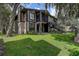 Well-maintained two-story condo building with manicured lawn and mature shade trees at 4012 Tumble Wood Trl # 104, Tampa, FL 33613