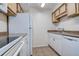 Kitchen features white appliances, wood cabinets, light countertop and tile flooring at 4012 Tumble Wood Trl # 104, Tampa, FL 33613