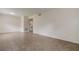 Spacious living room with tile flooring and a view into the kitchen at 4012 Tumble Wood Trl # 104, Tampa, FL 33613
