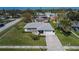 Aerial view of property showcasing well-maintained lawn, mature trees, and neighborhood at 4085 105Th N Ave, Clearwater, FL 33762