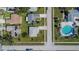 Birds-eye view of a residential street highlighting the property, nearby homes, and community pool at 4085 105Th N Ave, Clearwater, FL 33762