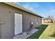 Side door to house with manicured lawn and garden at 4085 105Th N Ave, Clearwater, FL 33762