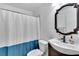 Clean bathroom with a modern vanity, decorative mirror, and shower with a curtain at 4085 105Th N Ave, Clearwater, FL 33762