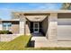 Covered front porch and entryway to the house with white brick pillars and a ceiling fan at 4085 105Th N Ave, Clearwater, FL 33762