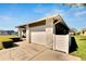 Side view of the house with garage, concrete driveway, and manicured yard in a residential neighborhood at 4085 105Th N Ave, Clearwater, FL 33762