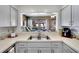 Bright kitchen featuring generous countertop space and a view to the sunroom at 4085 105Th N Ave, Clearwater, FL 33762