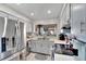 Well-lit kitchen with stainless steel refrigerator and white cabinets at 4085 105Th N Ave, Clearwater, FL 33762
