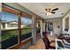 Bright sunroom with large windows, ceiling fan, and access to the living area at 4085 105Th N Ave, Clearwater, FL 33762
