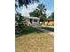 Inviting single-story home with a quaint porch, palm tree, and classic curb appeal at 4111 W Grace St, Tampa, FL 33607