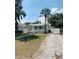 Charming one-story home with a welcoming front porch, palm tree, and ample parking space at 4111 W Grace St, Tampa, FL 33607